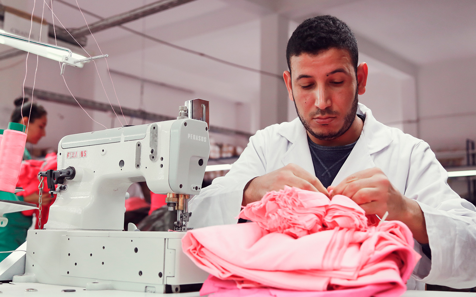 Beneficiary of the professional integration program working in a textile clothing workshop