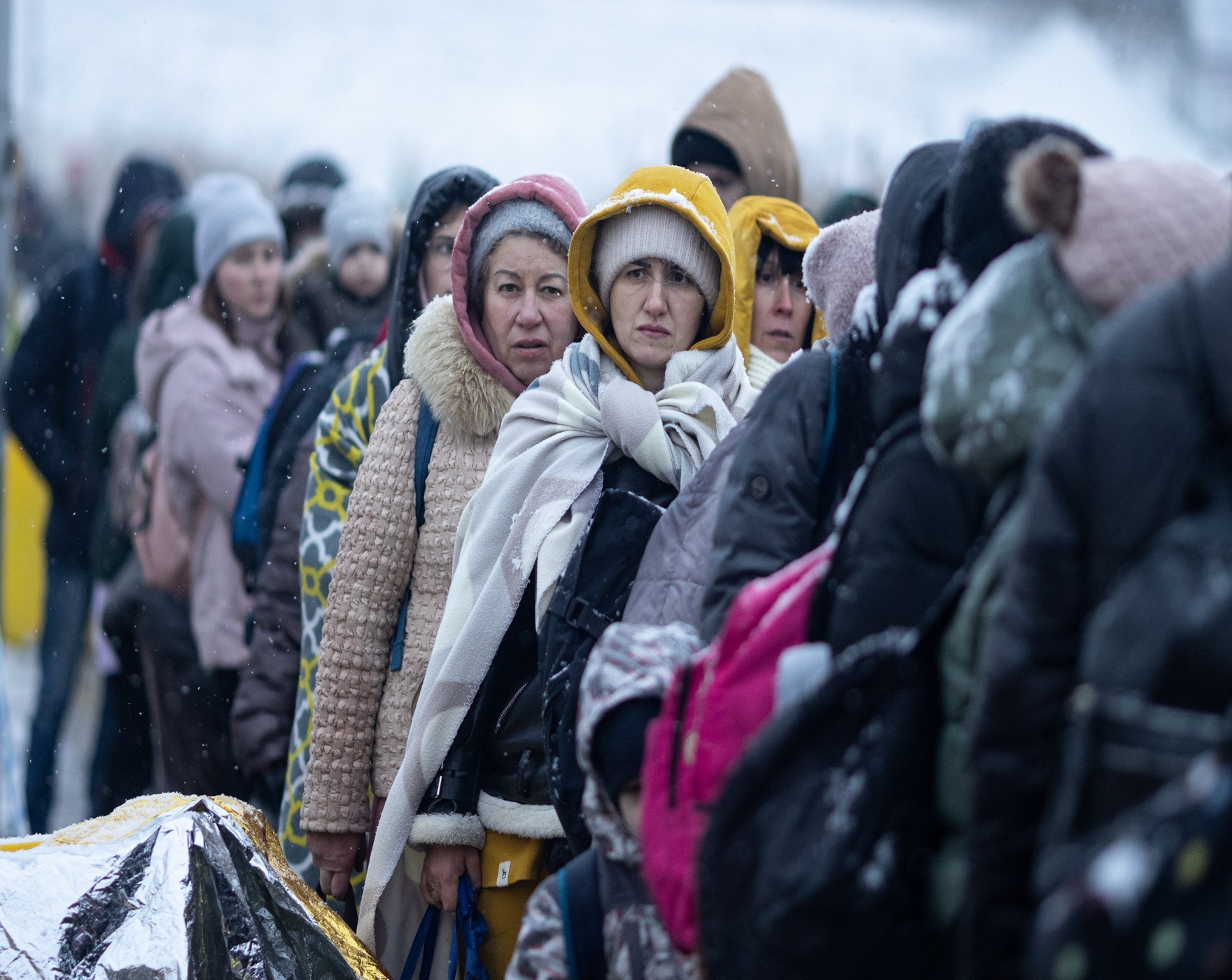 People cross the Medyka border crossing from Ukraine to Poland. 