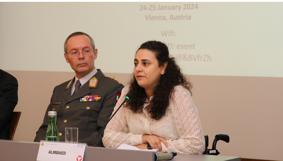 Marwa speaking at a conference on bombing in populated areas in Vienna in January 2024.; }}